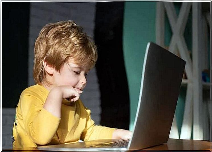 Boy getting distracted on notebool: how technology helps us during quarantine