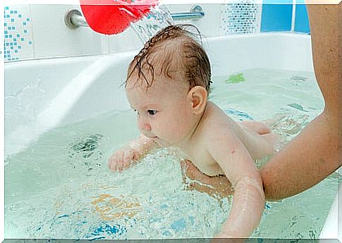 mother bathing baby 