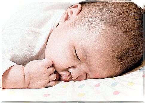 What should I do if my baby is lying on his stomach while sleeping?